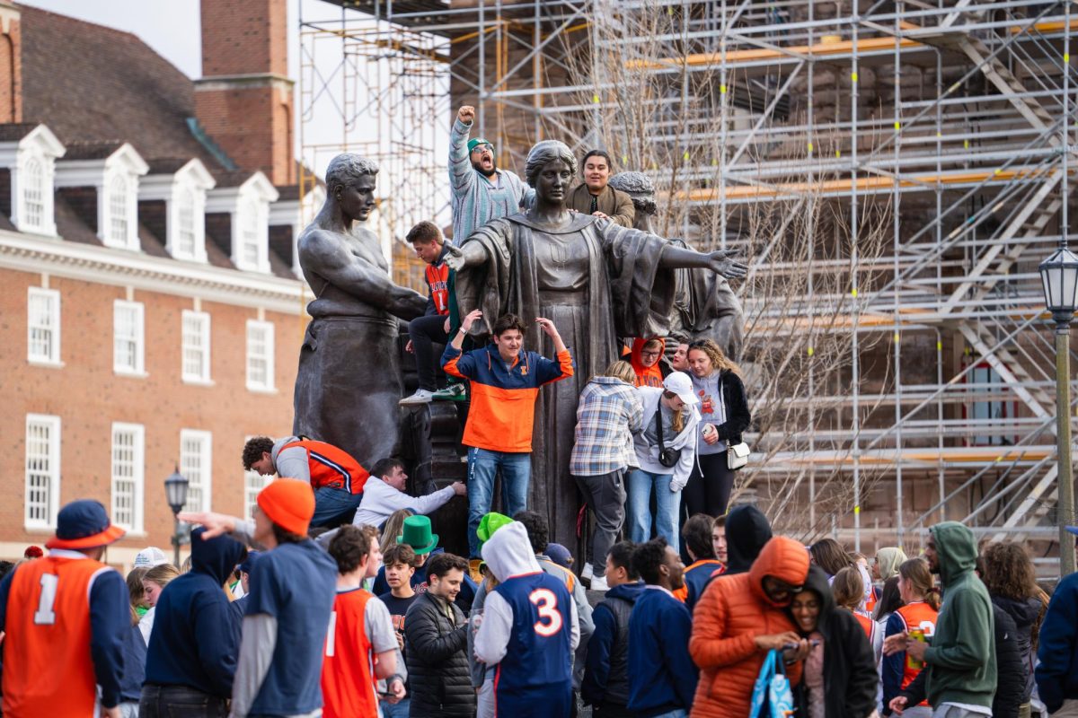 Illini basket ball fans excitedly celebrate at Alma Matter Illinois win over Wisconsin in the Big Ten tournament on Sunday afternoon. 