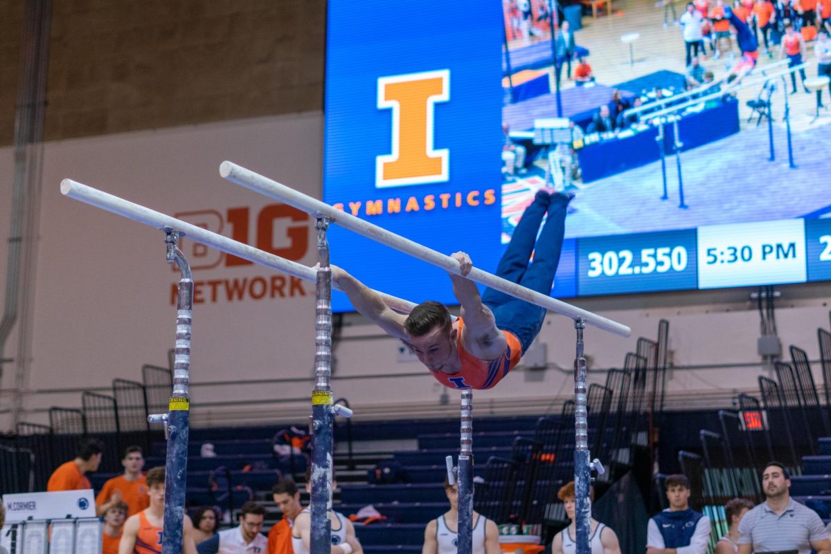 Graduate Student Michael Fletcher competes on the parallel bars during the Ninja Warrior Competition against Penn State on Feb. 4.