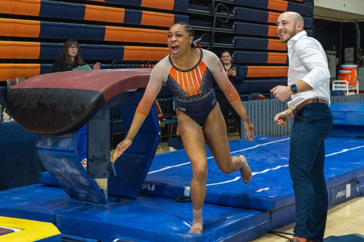 Junior Makayla Green celebrates after completing a successful vault during the meet against Minnesota on Feb. 18. 
