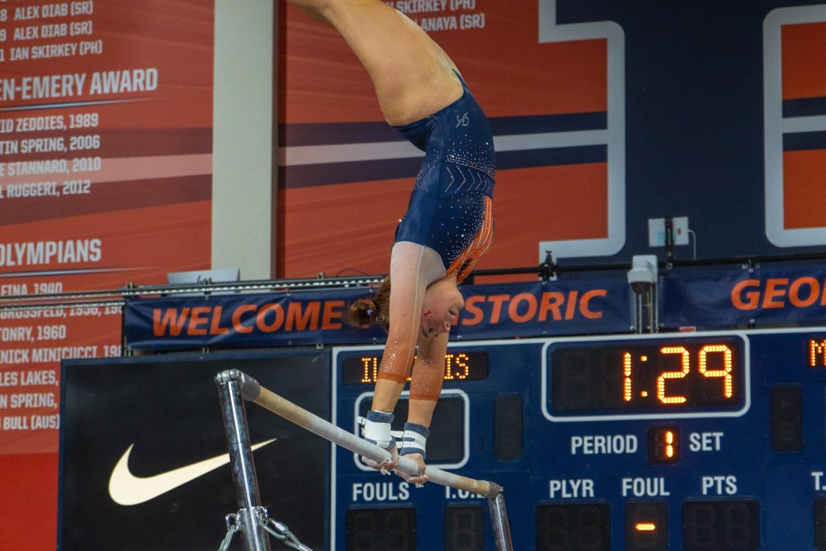 Freshman Lyden Saltness prepares a big swing on the uneven bars against Minnesota in Huff Hall Feb. 18.