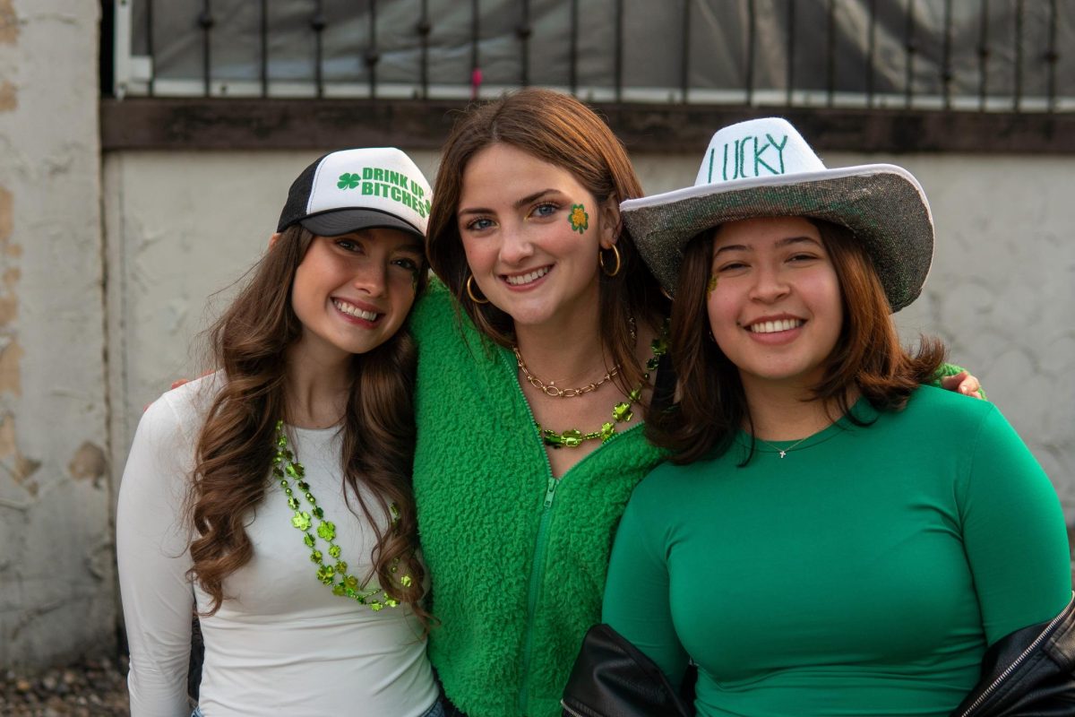 Sarah Coffman, senior in LAS, Dennielle Monge-Vargas, senior in LAS, and Jillian Butler, senior in Engineering, pose outside of The Red Lion while celebrating Unofficial. 