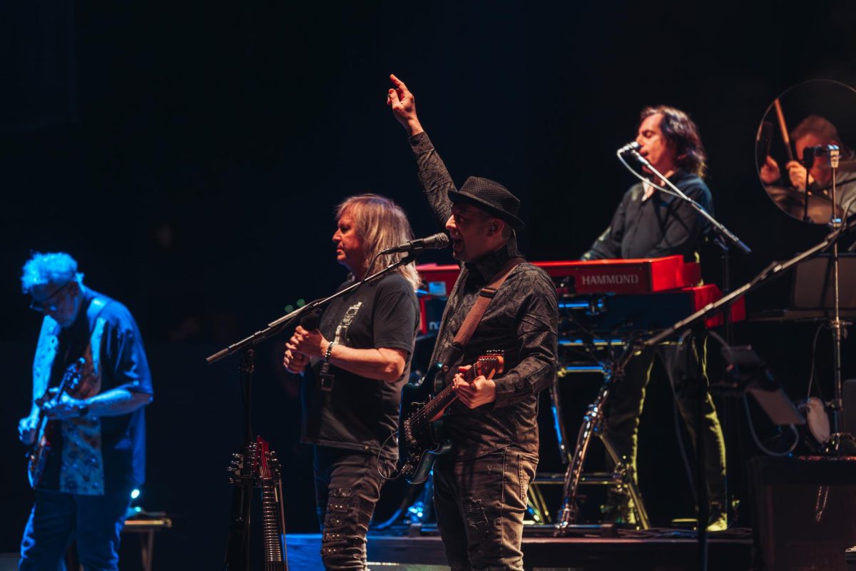 Guitarist and violinist Joe Deninzon points in the air during the 50 years of Kansas show at the Virginia Theater in Champaign.