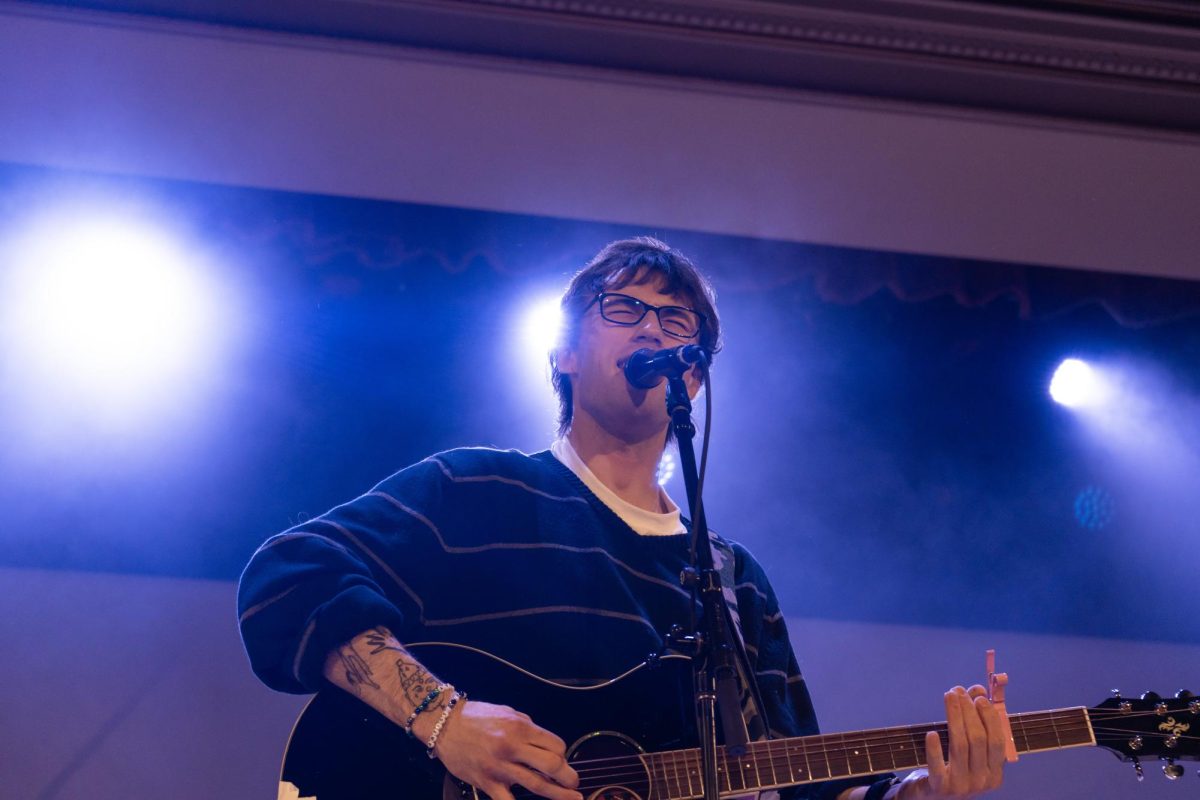 Peter McPoland sings passionately at the Foellinger Auditorium on Thursday during his tour of the Midwest.