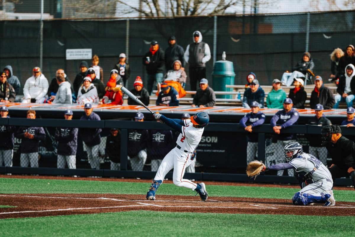 Graduate student Brody Harding smashes the ball towards the fence against Northeastern on April 20.
