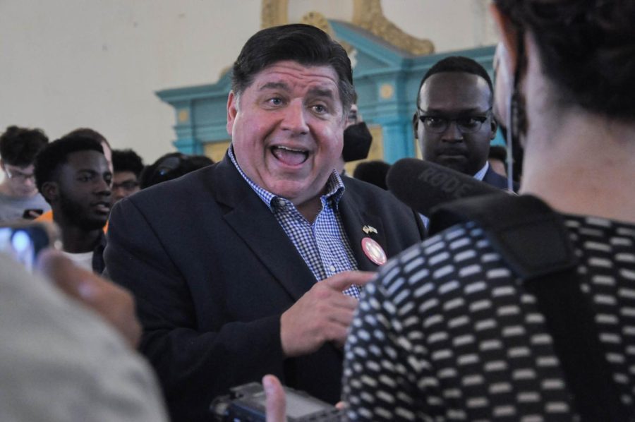 Illinois Gov. JB Pritzker speaks to the press after visiting the Illini Union ballroom for an event hosted by the Illini Democrats on Thursday. Pritzker spoke alongside Lt. Gov. Juliana Stratton, candidate Nikki Budzinski, Sen. Scott Bennett and Champaign County Clerk Aaron Ammons.