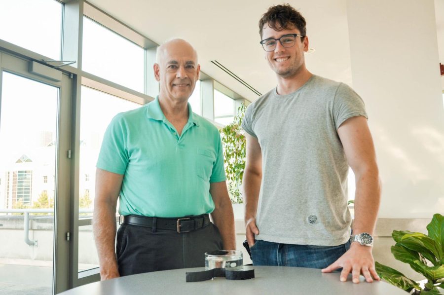 Joseph Lyding, professor in Engineering, and Branden Wolan, graduate student studying electrical and computer engineering, pose with the 3D printed carbon nanotube film in the Nick Holonyak Micro and Nanotechnology Laboratory on Friday. 
