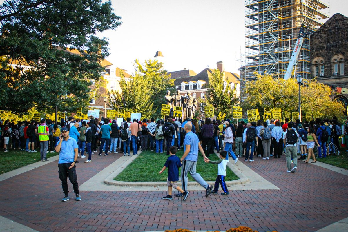 Advocates, students and members of the community gather in front of the Alma Mater statue on Thursday as Students for Justice in Palestine hold a protest.