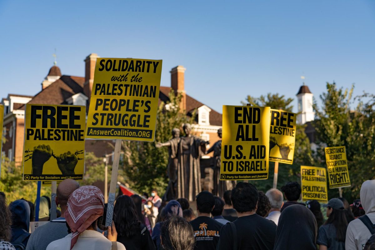 Protestors gather in front of the Alma Mater statue on Thursday.