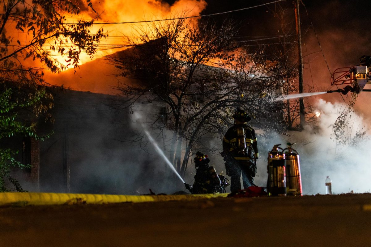 Firefighters with the Champaign Police Department attempt to put out the flames at a building on the corner of First and Clark streets.