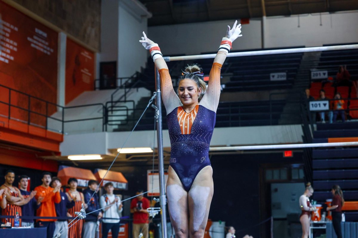 Rising fifth-year Amelia Knight strikes a pose as she dismounts the uneven bars during a gymnastics meet against Minnesota on Feb. 18.