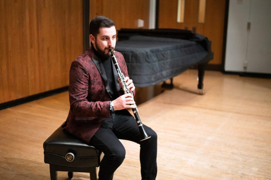 Andrew Buckley, graduate student in FAA, practices playing his clarinet inside one of the auditoriums within the Universitys School of Music building. Buckley will be debuting his album, “Where We Go Next,” this spring at the Smith Memorial Hall.
