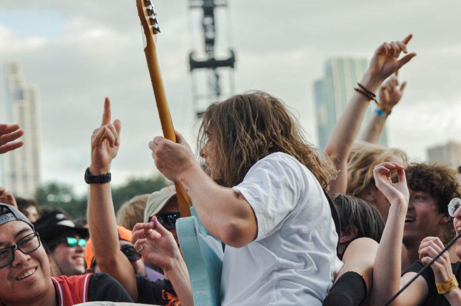 Lee Kiernan, guitarist for rock band IDLES, rushes into the crowd with his guitar during the groups performance on the Bud Light Seltzer stage on Saturday. 