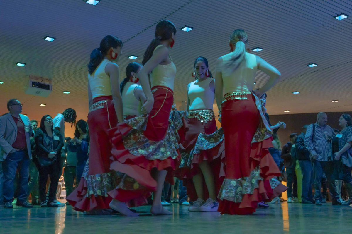 A group of dancers take over the dance floor at the FIESTA | Bailando through the Decades event at the Krannert Center for the Performing Arts on Sunday, April 7.