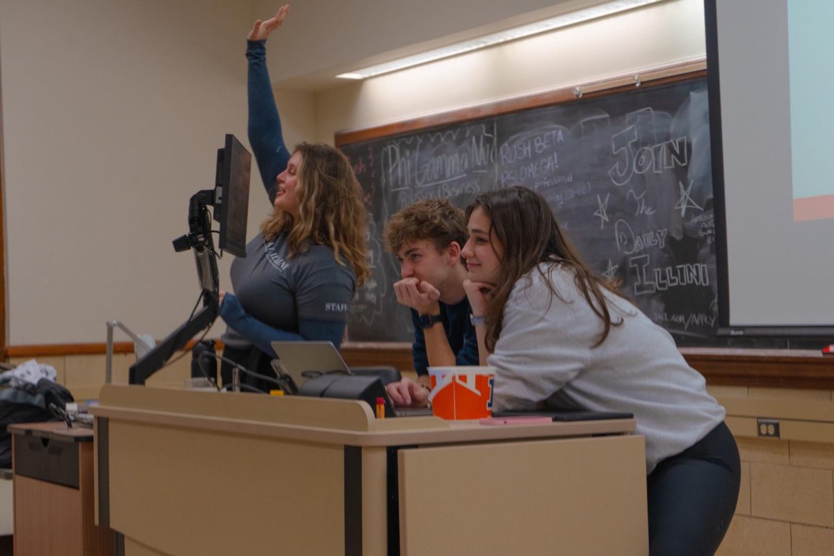 Lisa Chasanov, Jacob Slabosz and Lika Lezhava present at an Illini Media Company recruitment night on Jan. 23.