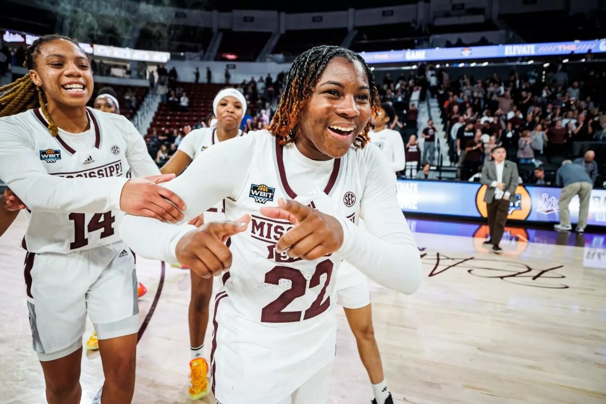 Freshmen guard Jasmine Brown-Hagger celebrates advancing to the second round of the WBIT with her teammates.