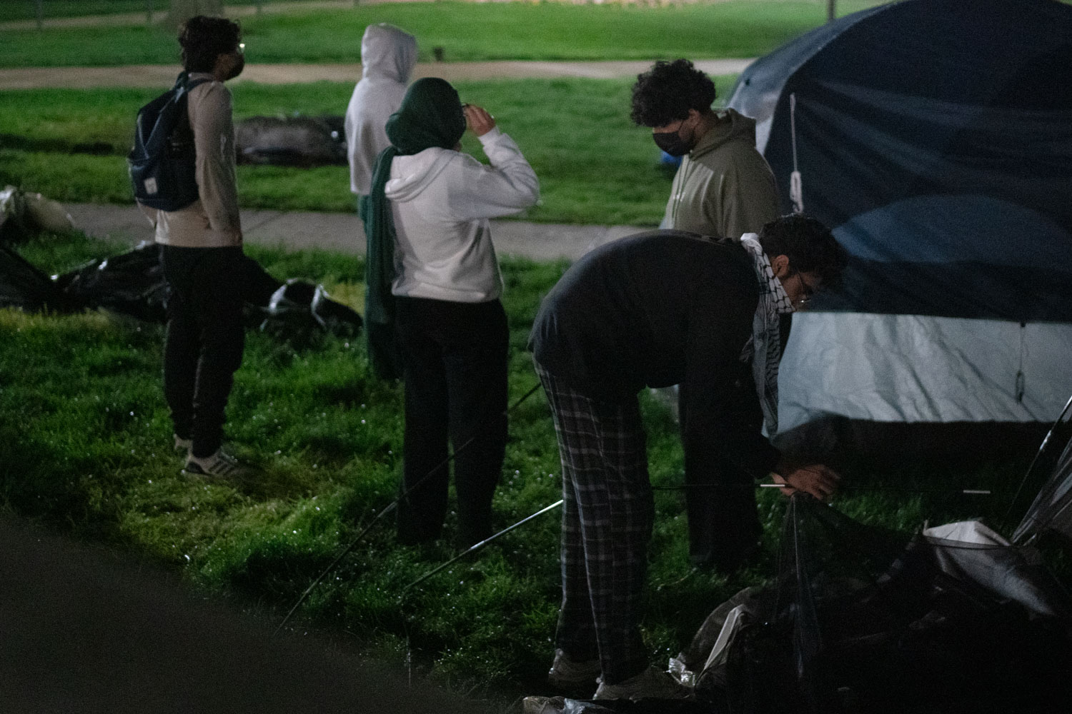 Protesters dismantle tents as they converge early Friday morning.