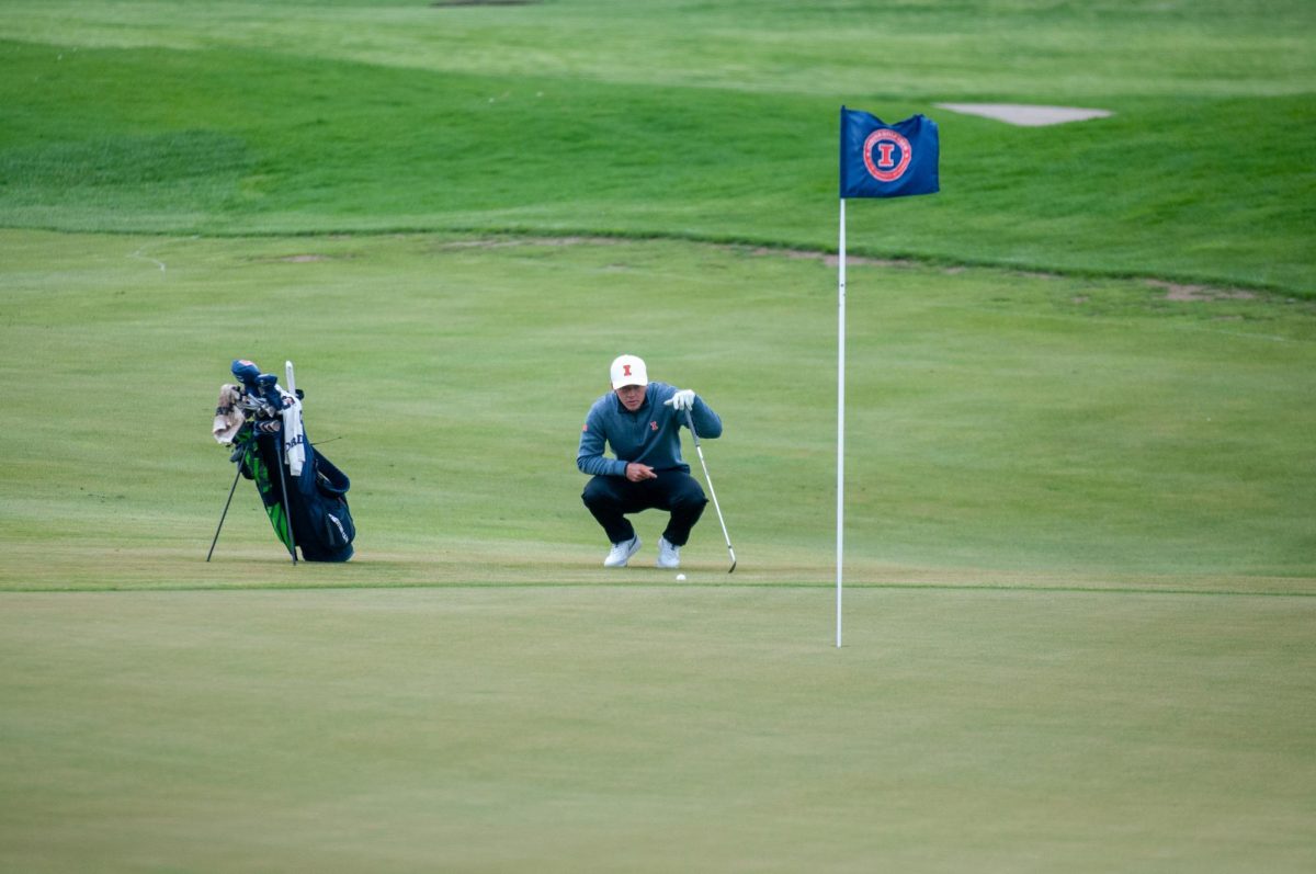 Senior Piercen Hunt reads the break of the green on hole five of the University of Illini Golf Course during the 2023 Spring Colligate.