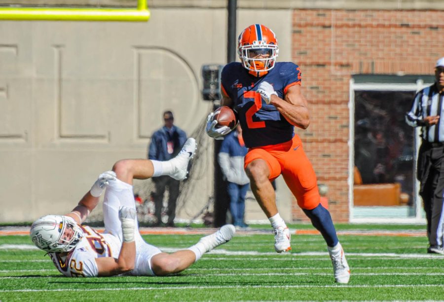 Junior running back Chase Brown rushes past a Minnesota offensive player on Saturday. 