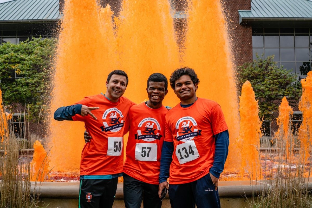 Postdoctoral researchers Seemesh Bhaskar, Renato Azevedo and Samuel Olatunji stand in front of the fountain at the Alice Campbell Alumni Center for Homecoming Kickoff on Oct. 15. Official Homecoming events occurred from Oct. 15-22. 
