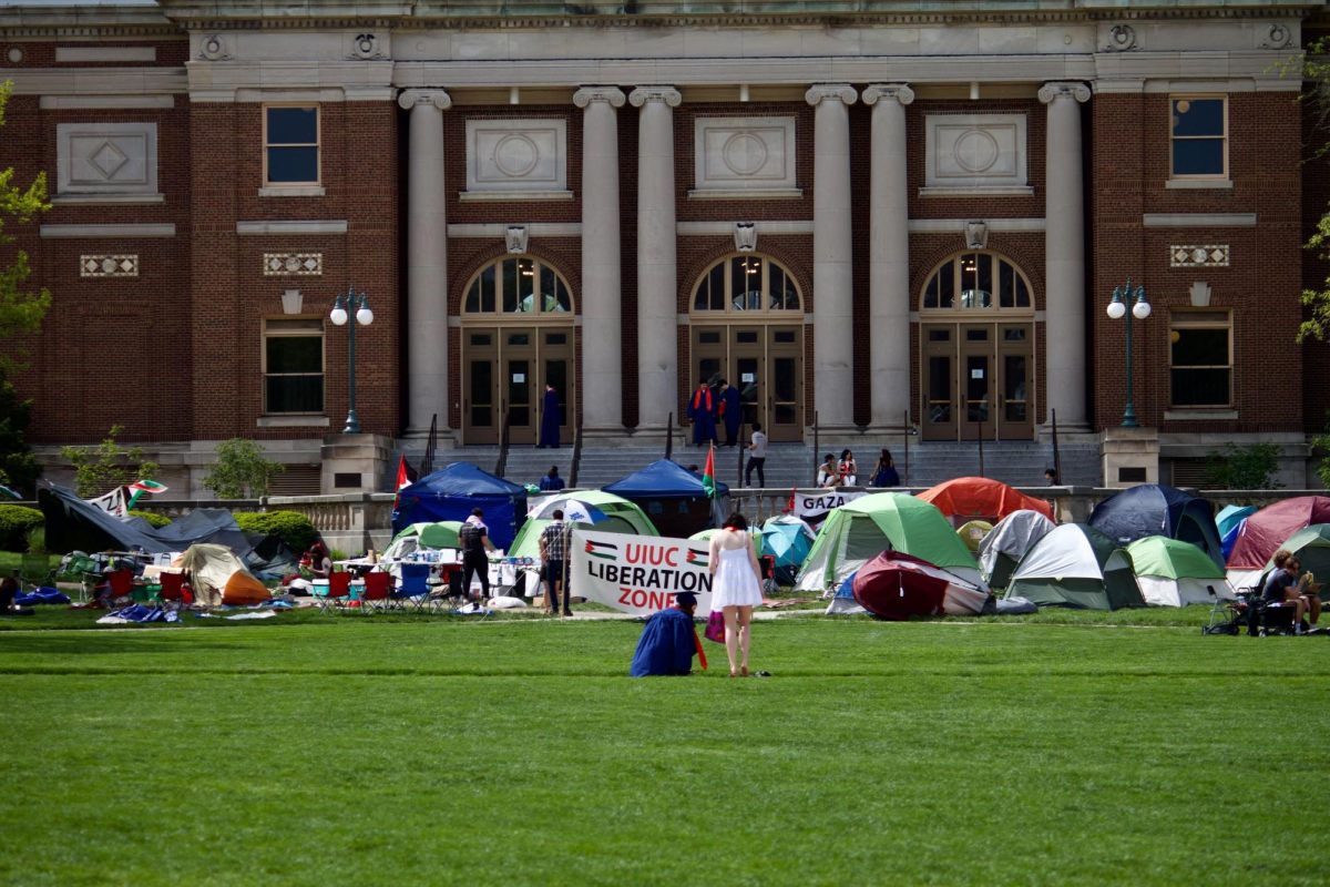 Seniors continue to take senior pictures on the quad despite the encampment taking up space there.