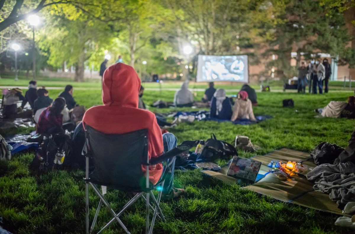 Protestors gathered around a projector screen to watch La Bataille dAlger (Battle of Algiers)