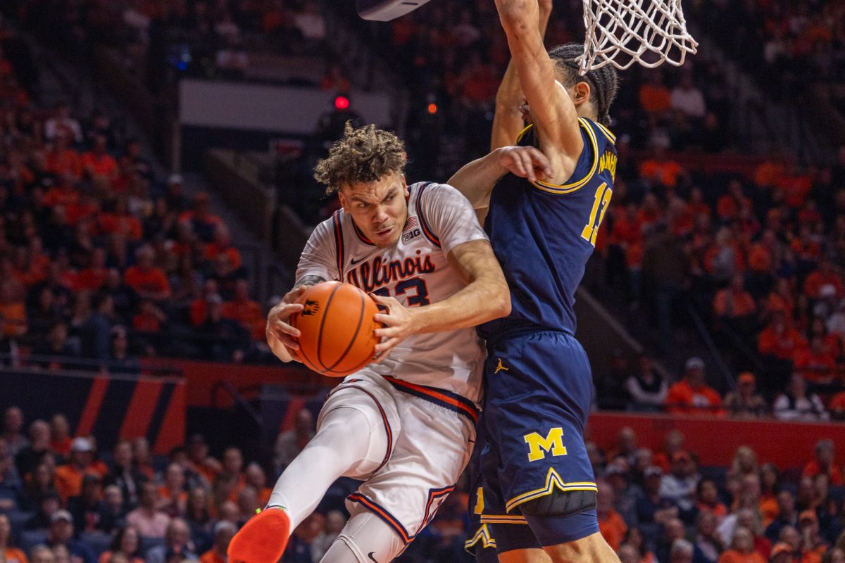 Senior Forward Coleman Hawkins drives to the basket during a basketball game against Michigan on Feb 13.