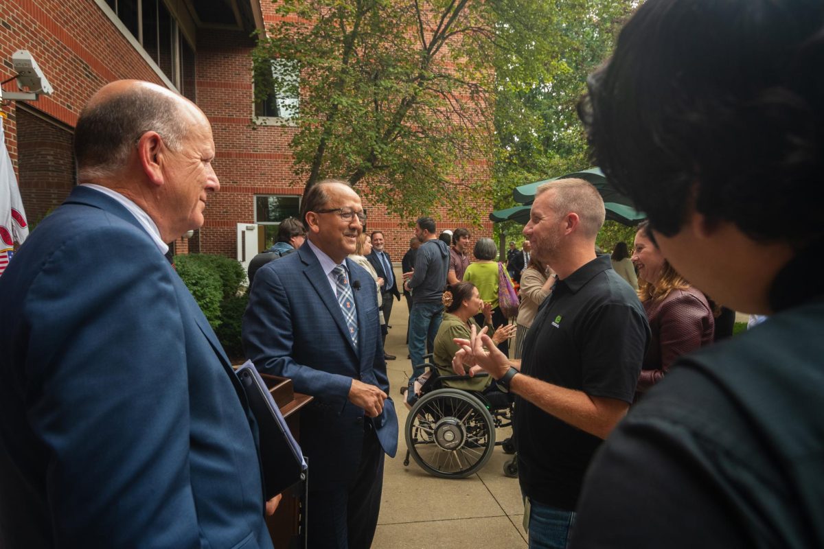 Dean of Grainger College of Engineering Rashid Bashir speaking with members at the post panel gathering on Sept. 9.
