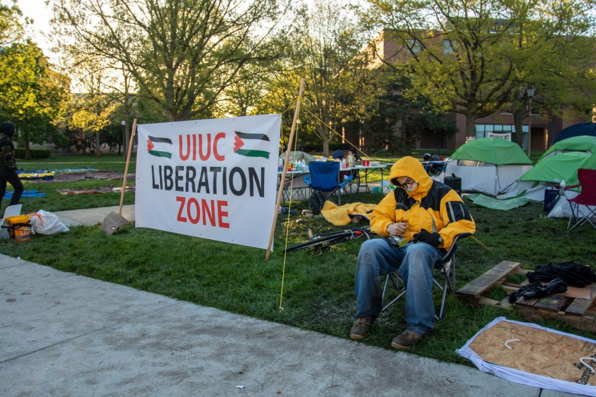 Protester rests beside the self-proclaimed liberation zone Tuesday morning.