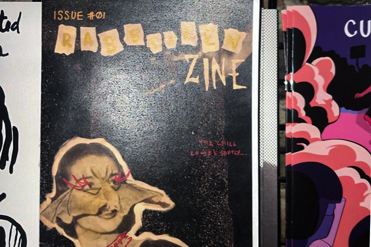 The cover of the zine, Rabbiteen, displayed with other zines and comics in Quimbys, a Chicago bookstore. Rabbiteen centers around the dark alternative subculture in music, visual arts, and more. 