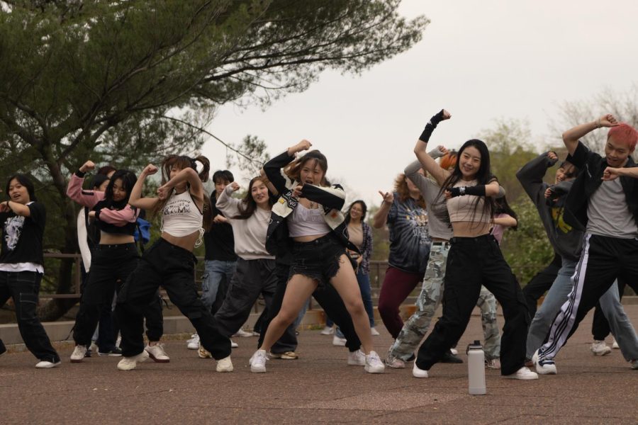 Members of the K-pop Dance groups TNB, K Project and Choom participate in a Random Play Dance outside of the Krannert Center for Performing Arts on Friday.