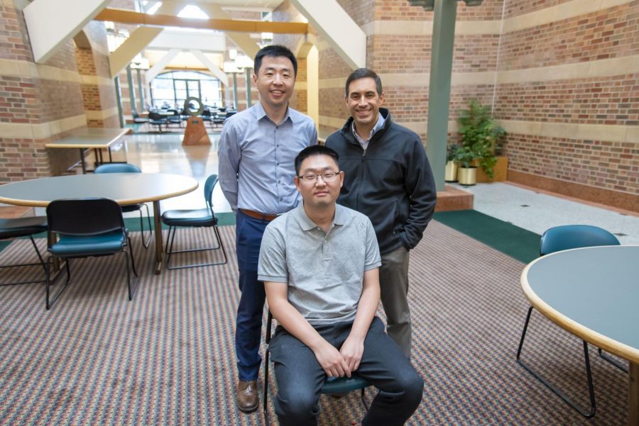 Professors Pengfei Song and Daniel Llano pose with graduate student Qi You who aided in Song and Llano’s research. Song and Llano collaborated in developing ultrasound imaging tools that can help study Alzheimer’s disease. 