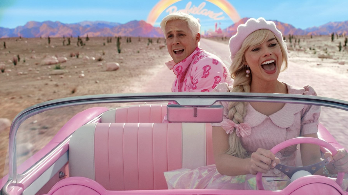 Ken (Ryan Gosling) and Barbie (Margot Robbie) ride in a pink car in Barbie (2023)