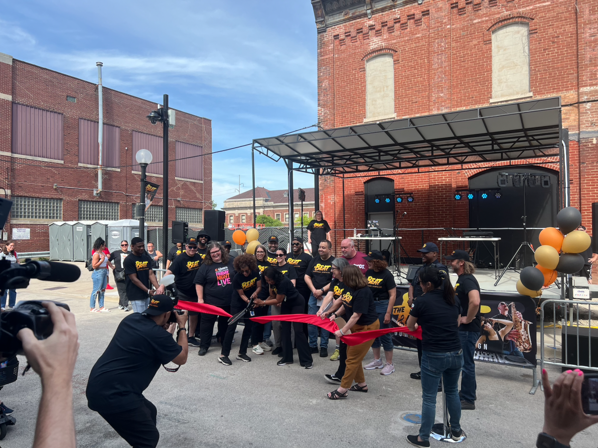 The Beat organizers, including the mayor, city manager and city council members cut a ribbon in front of the stage. The city organized downtown festival districts for the summer with live music and legal alcohol consumption.