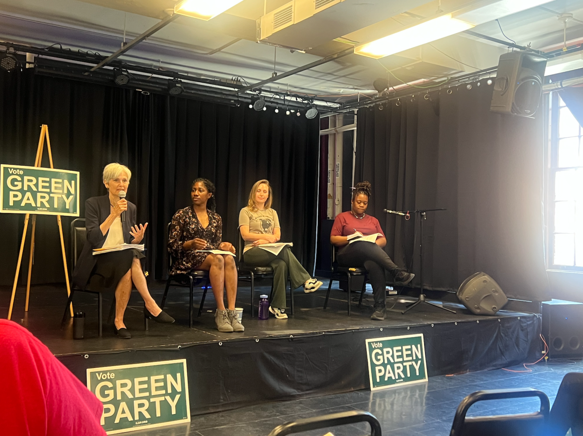 Jill Stein (left) speaks to audience members at a panel at the Urbana-Champaign Independent Media Center on Thursday, next to Chibu Asonye (middle-left).