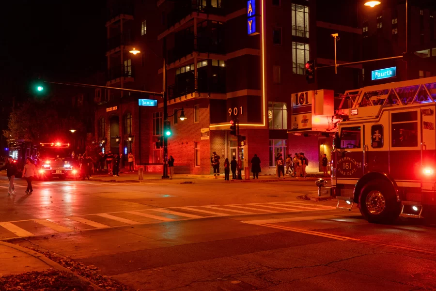 CU fire department post outside 901 S. Fourth St. as residents evacuate the building on Thursday. The fire was caused by a trash bin catching flame in an apartment which alerted the fire department but the bin was put out through the units sprinkler system.