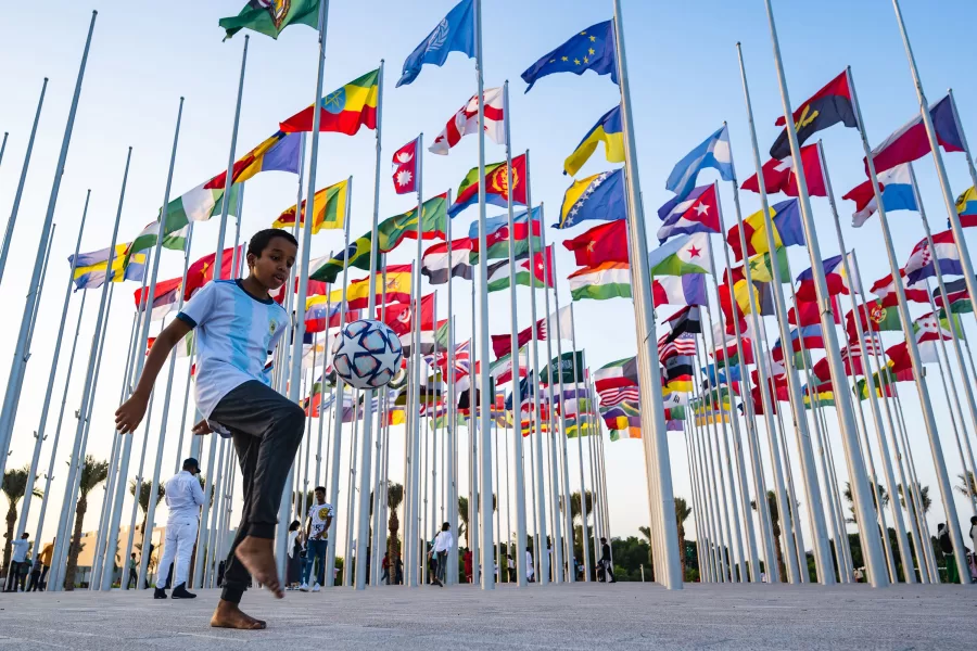 A boy plays with a ball at the flag plaza in Doha, Qatar on Nov. 15. Columnist Maggie Knutte argues that Qatar should have not hosted the 2022 FIFA World Cup due to the increase in deaths of migrant workers in relation to the stadiums being built for the games. 